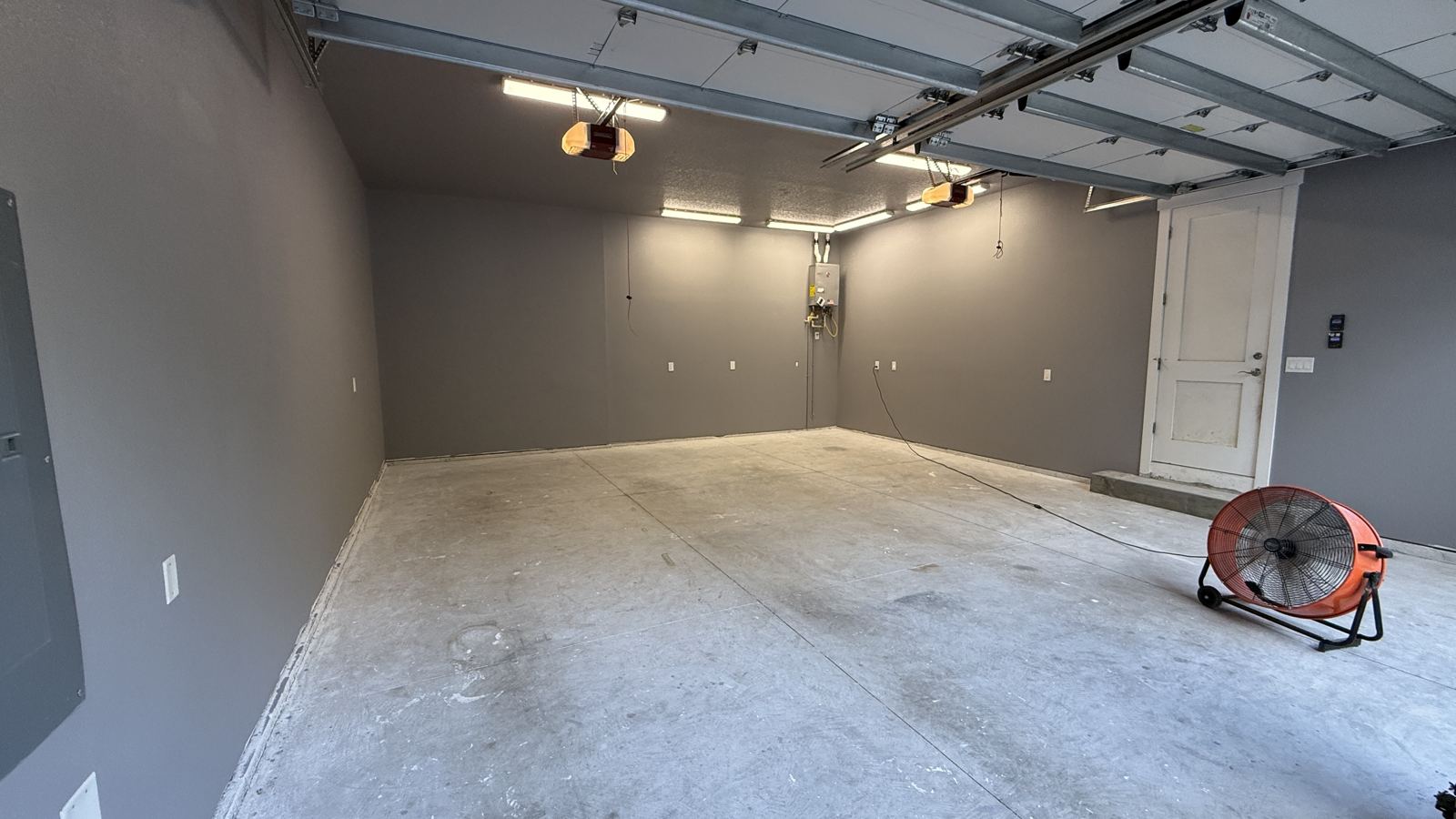 Empty garage with bare concrete slab before coating
