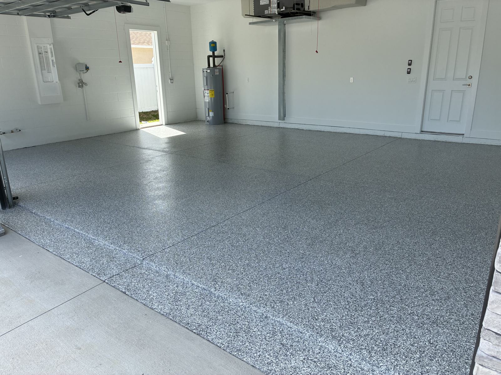 Gray flake garage floor coating in a new construction home