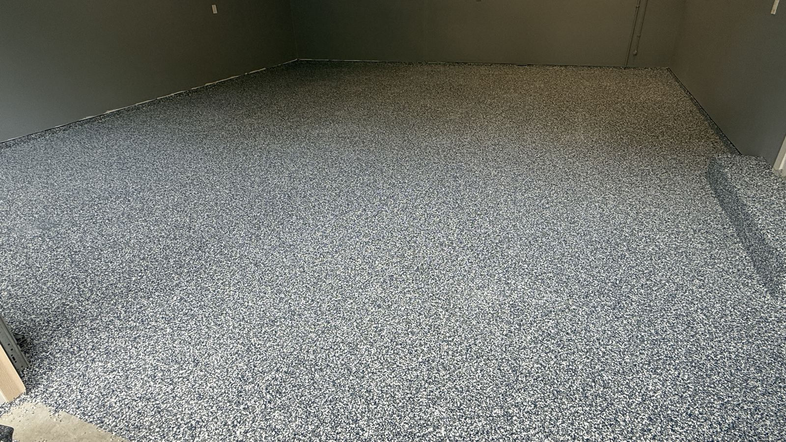 Finished gray and black flake garage floor after coating